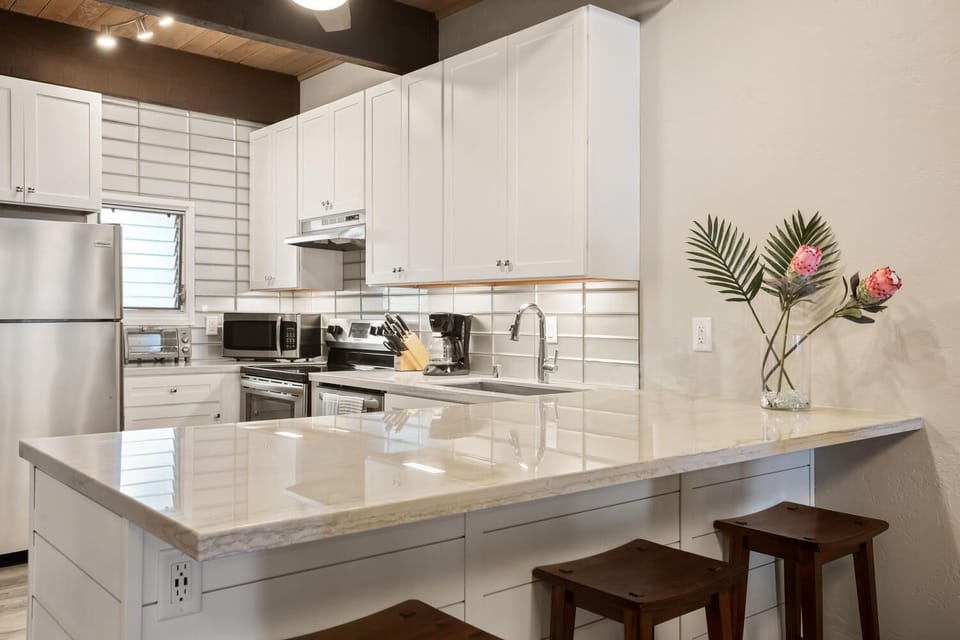 Kitchen with stainless steel appliances and quartzite countertops