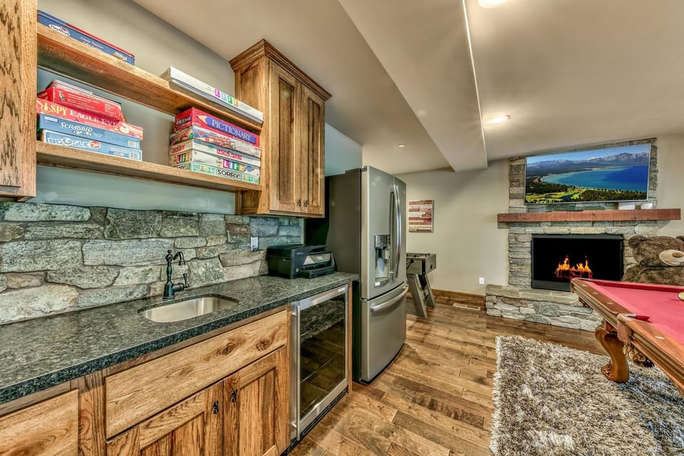 Cozy game room with stone fireplace and rustic charm