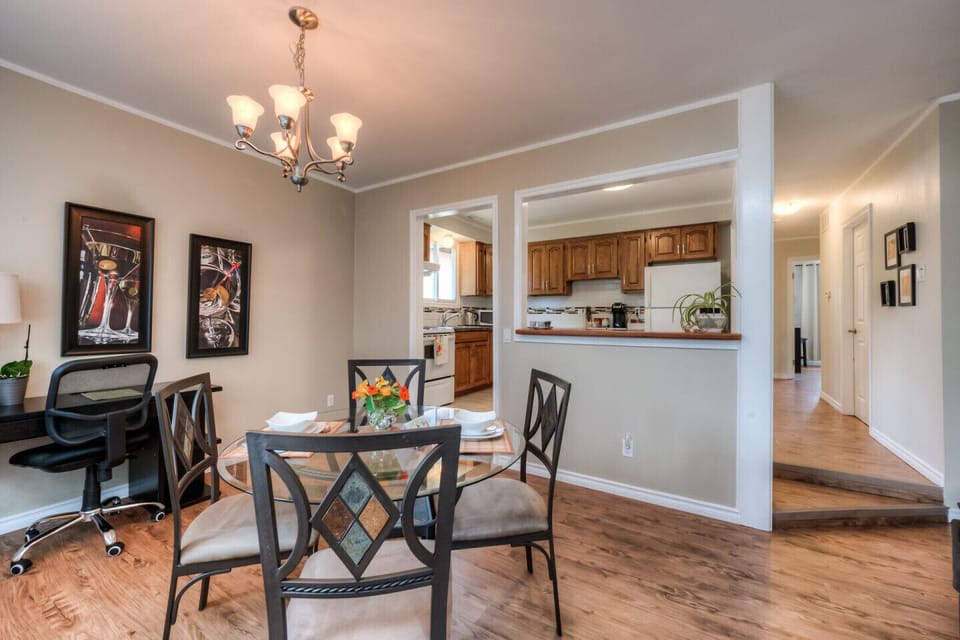 DINING ROOM  has  elegant glass table and comfy chairs. Large windows keep this room well-lit and illuminated with sunshine. In the corner you will find the laptop friendly workplace.