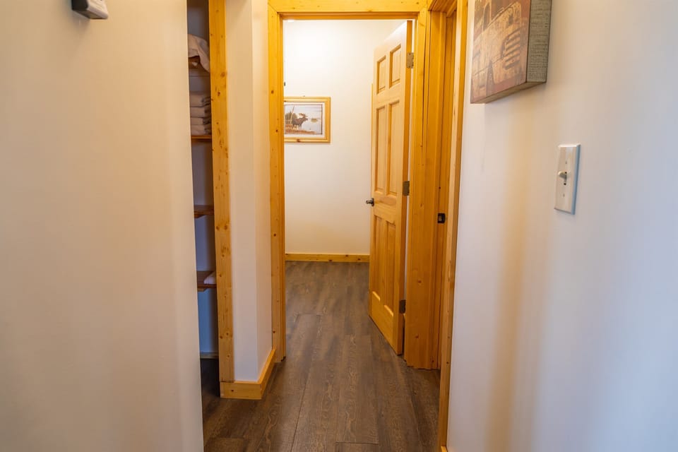 Hallway with bathroom on the left, Bedroom 1 straight ahead and Bedroom 2 on the right