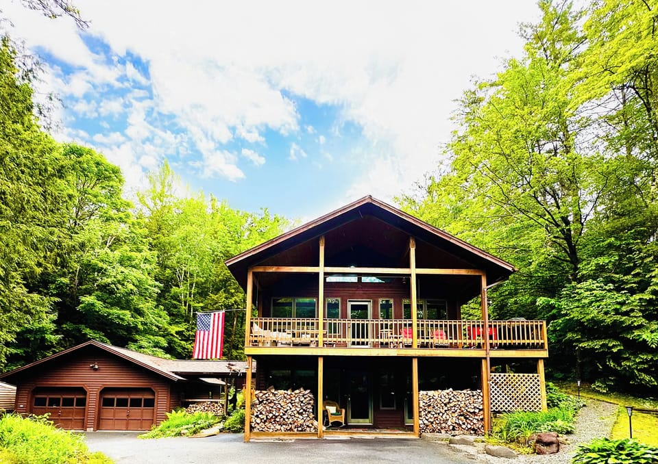 Two-level Chalet with wrap-around porch to back deck and fire pit. 