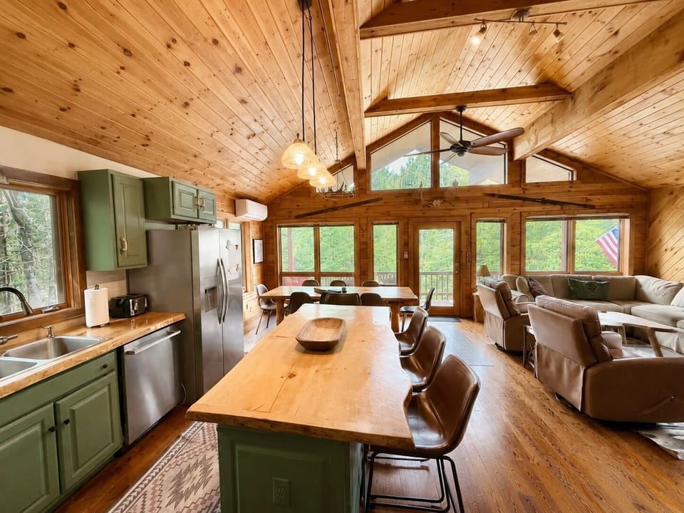 View from kitchen island. Door to wrap around porch with seating and grill