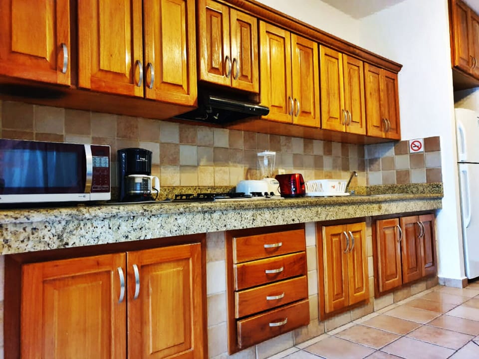 kitchen with microwave, coffee maker, toaster and all supplies to cook 