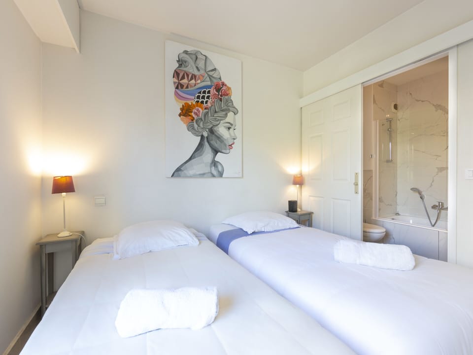 second bedroom with 2 singles beds and private bathroom