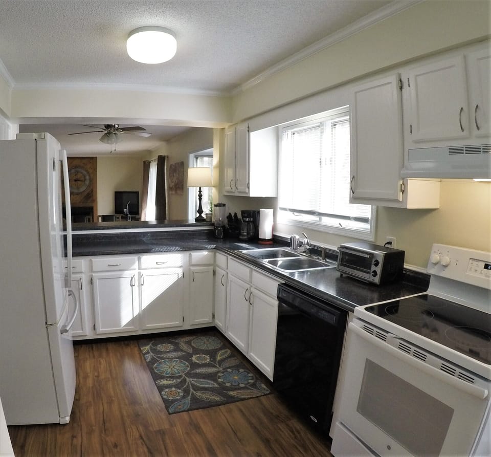 Large capacity French door fridge, Whirlpool dishwasher, open to living room. 