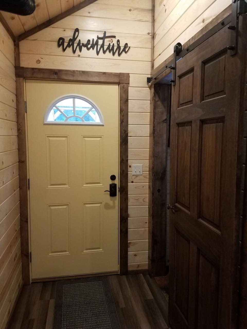 Hallway with barn door to bathroom.