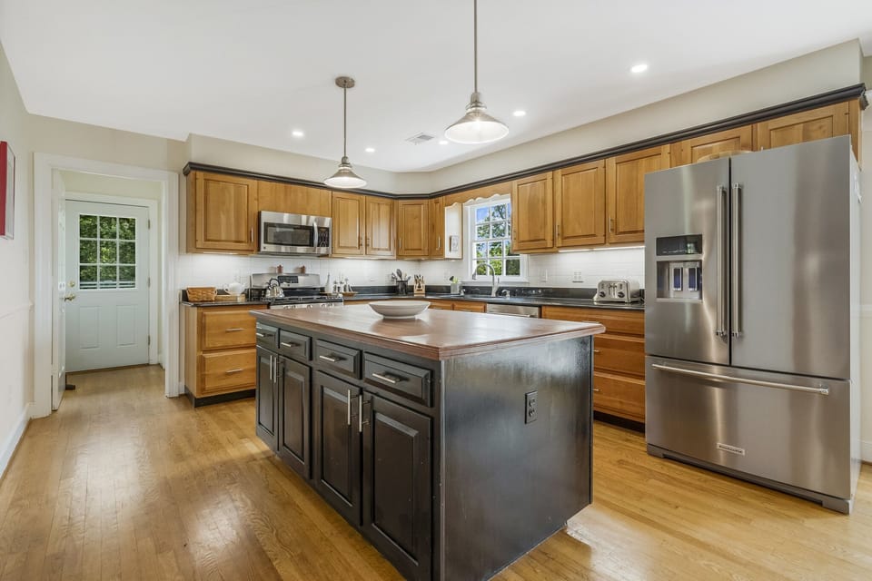 Granite countertops, cherry cabinetry and an island to prepare/serve your meals.