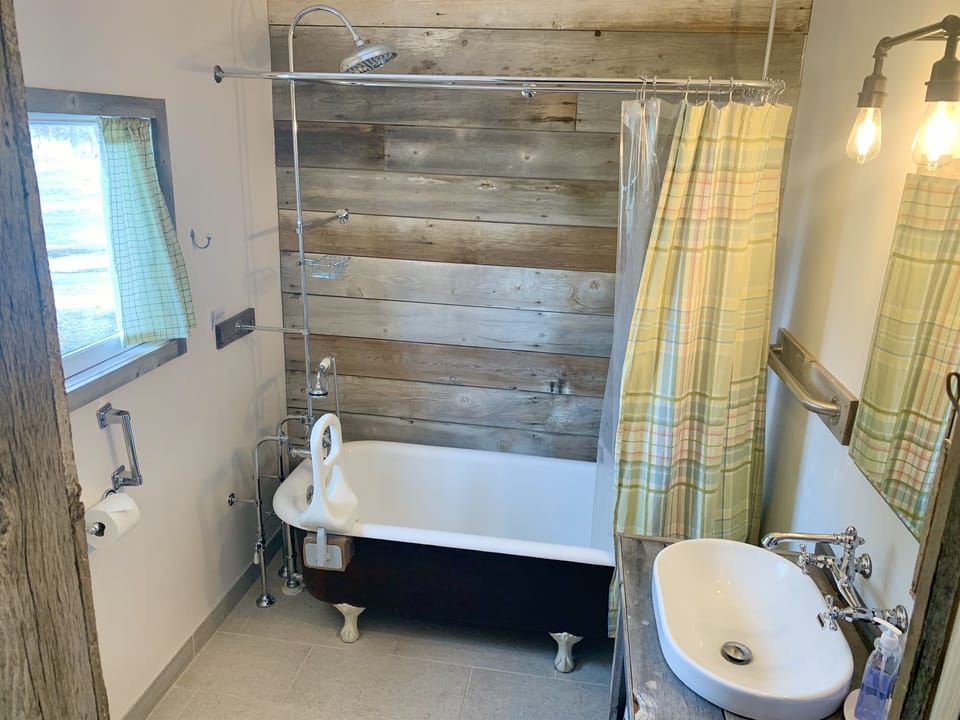 Master Bath, ~1890's cast iron tub, property barn wood.