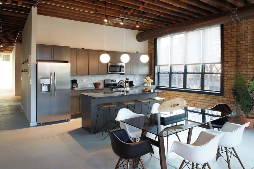 Gourmet kitchen with gas range, stainless appliances, and granite island