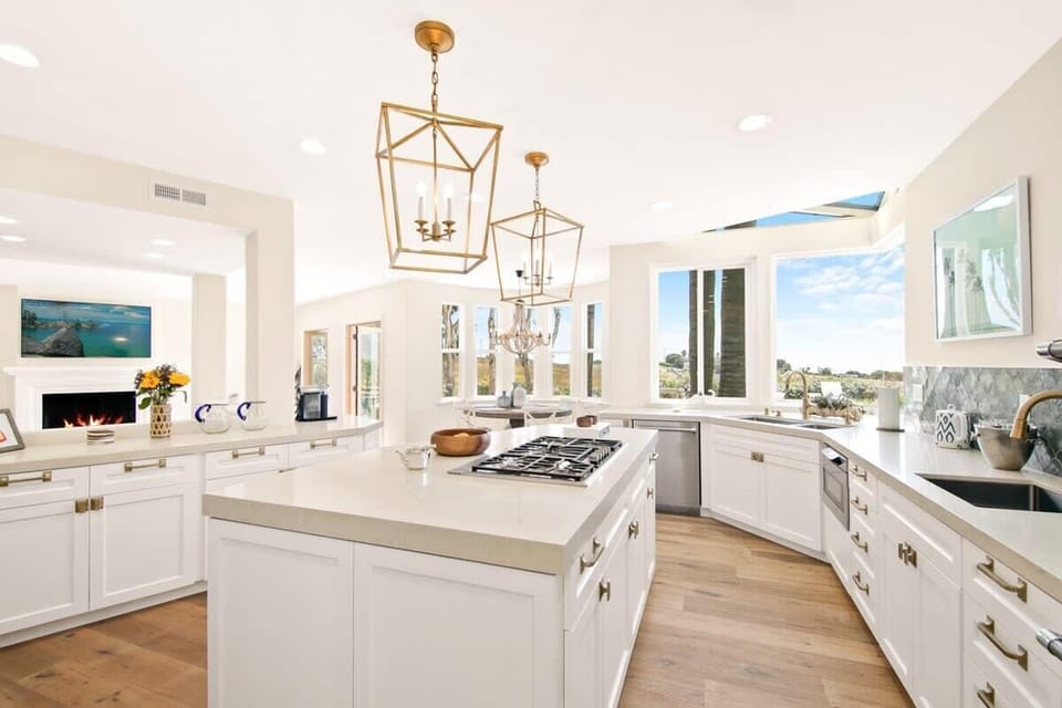An entertainers dream kitchen with upgraded appliances overlooking the luxury outdoor space.