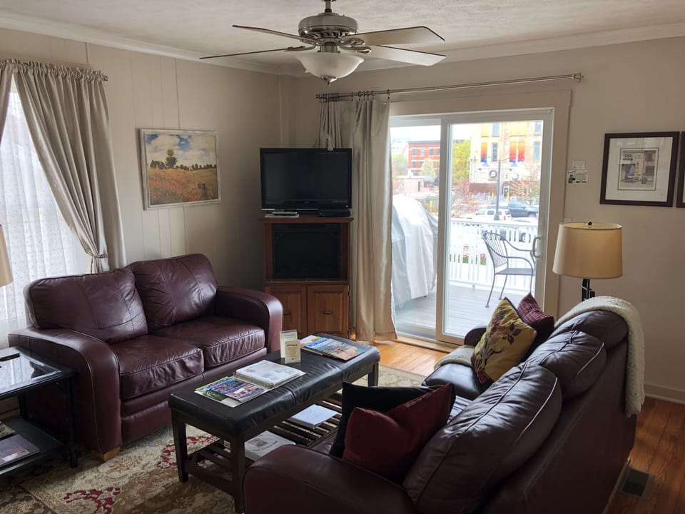 Living room with 40” Chromecast  TV and access to deck