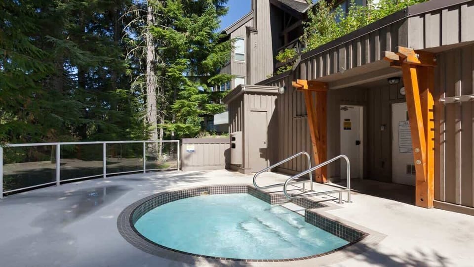 - Outdoor hot tub surrounded by tall evergreens for ultimate mountain relaxation  
- Soak under the stars after skiing or hiking through scenic forest trails  
- Refreshing outdoor retreat designed for year-round comfort and rejuvenation  
