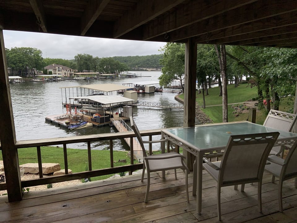 Lower porch with more dining furniture .