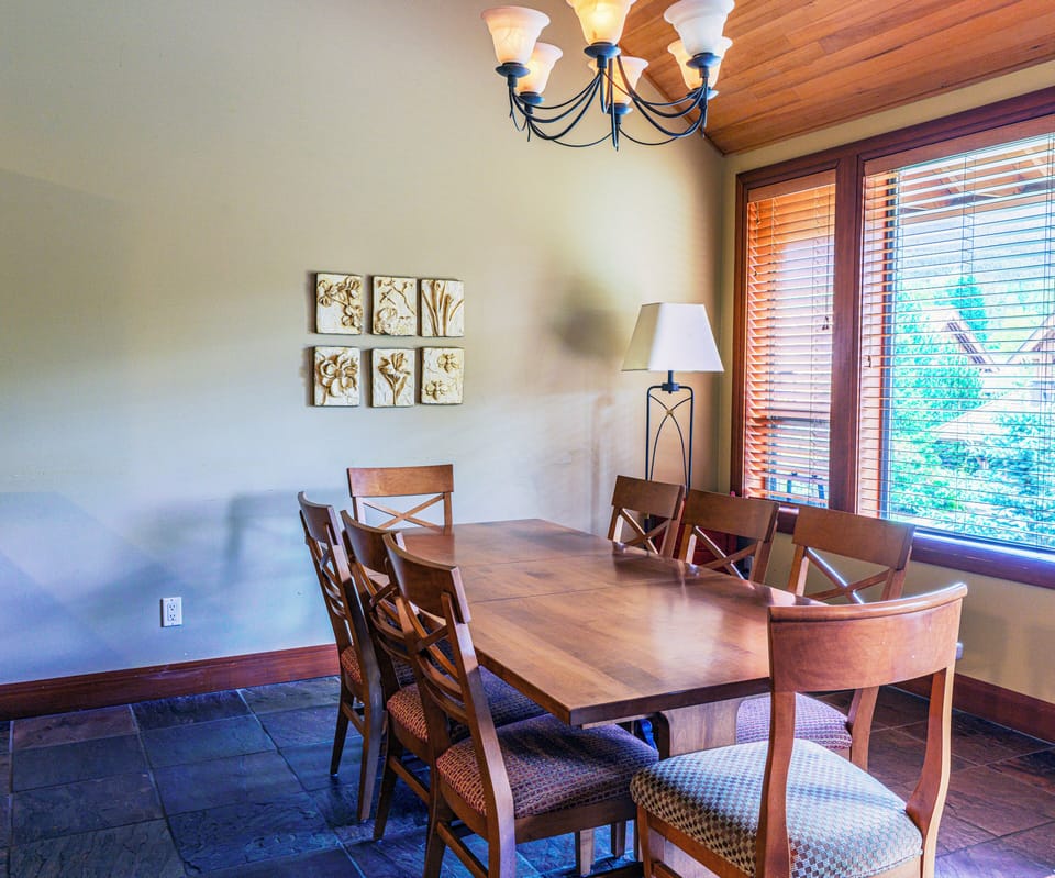 DINING AREA WITH VIEW OF BLACKCOMB MOUNTAIN AND AMPLE SEATING FOR EIGHT PEOPLE
