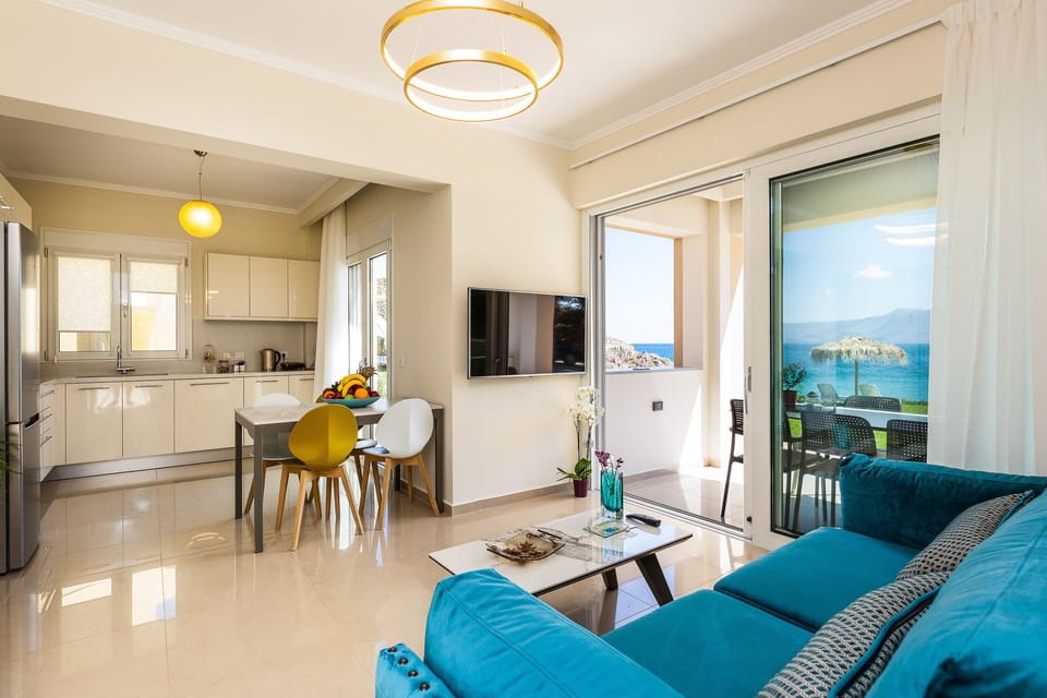 Open plan area featuring the kitchen, dining table and living room.