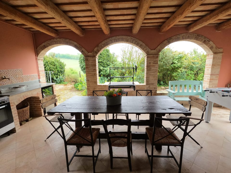 Outdoor kitchen with foosball, Argentinian grill, cooker and fridge