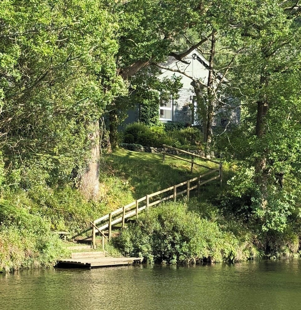 Riverside - hidden behind the tree's with its own private jetty . 