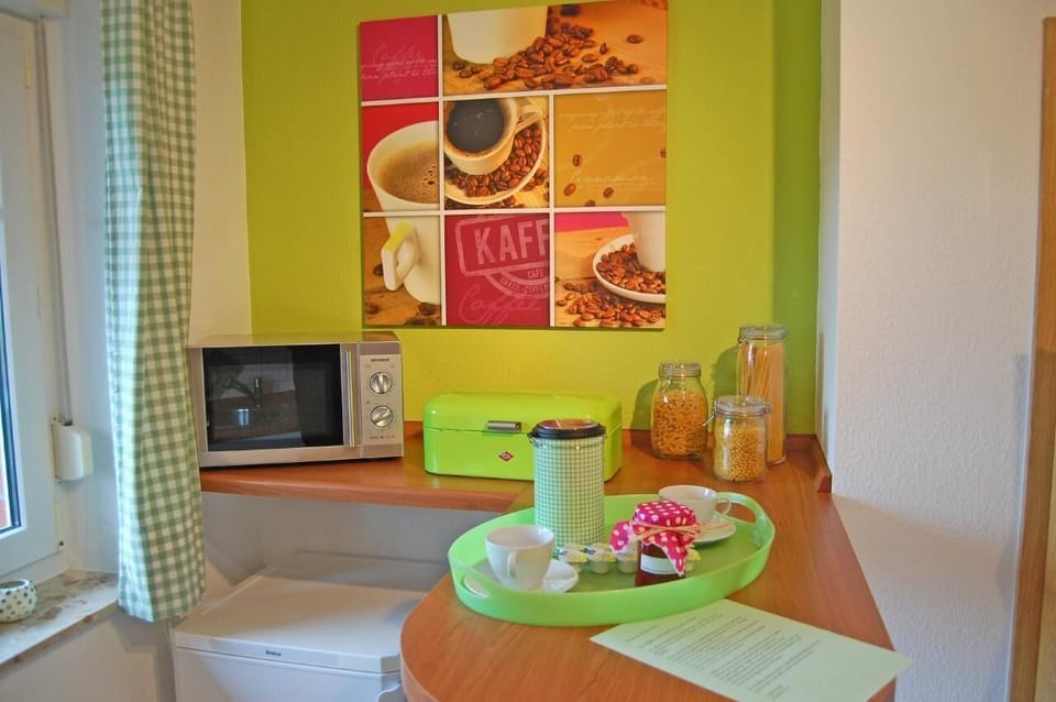 Kitchen counter with microwave and second fridge freezer.