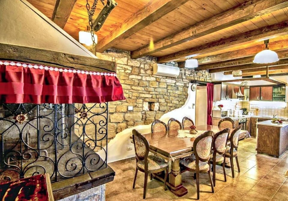 The dining area with dining table and chairs, equipped kitchen