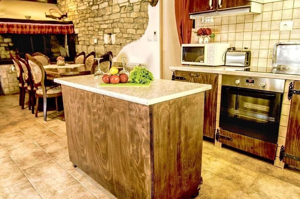 The kitchen equipped with a refrigerator, oven, microwave, toaster, and more