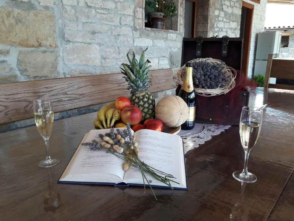 The solid wooden table decorated with lavender, Istrian wine, and fruit