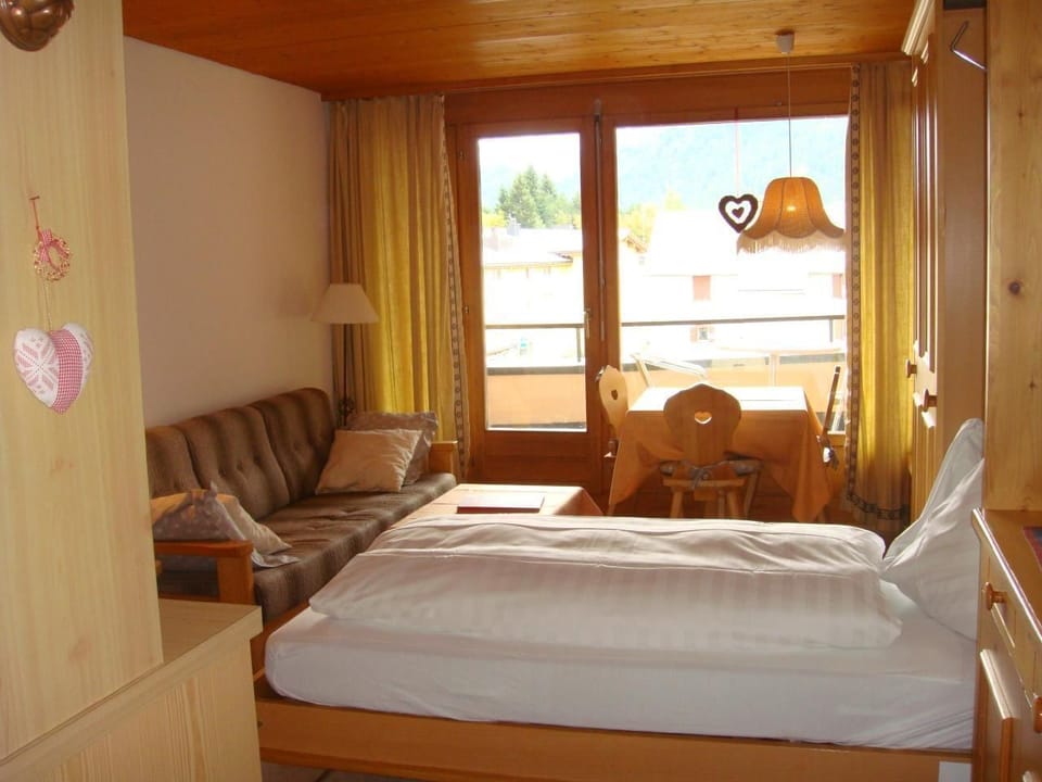 dining and living room with folding bed