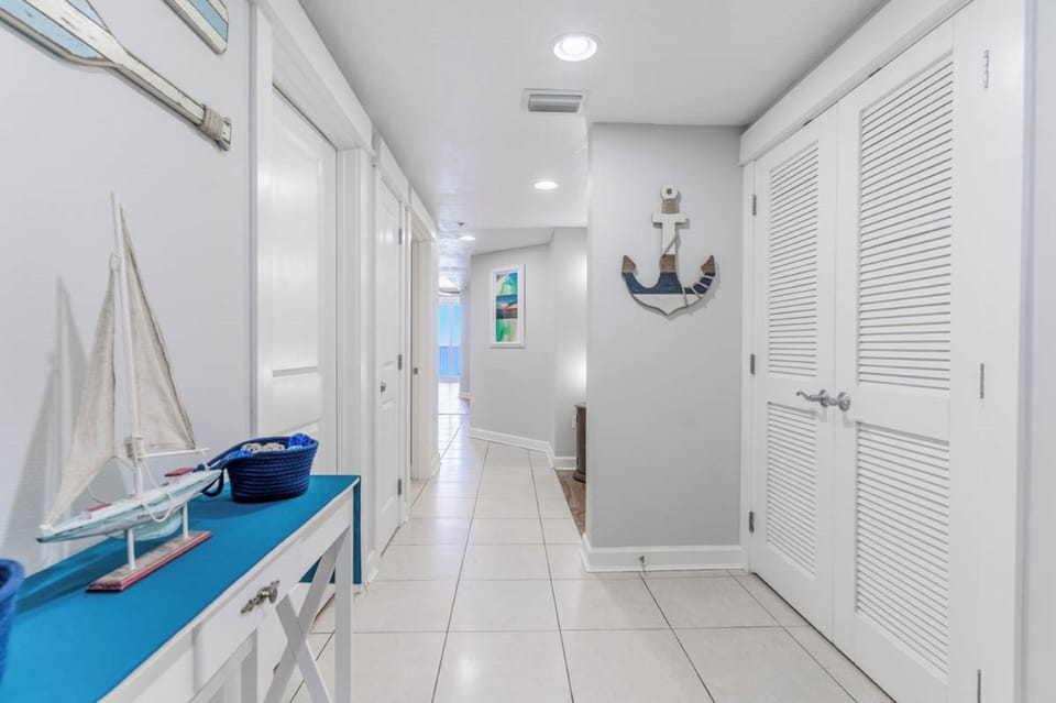 Your coastal retreat hallway welcomes you with crisp nautical décor and bright, spacious design that sets the perfect tone for relaxation.
