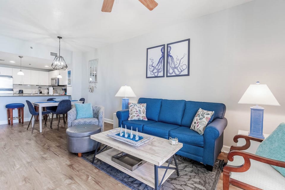 Sink into this vibrant blue sofa and feel the coastal vibes surround you in this thoughtfully designed open living space.