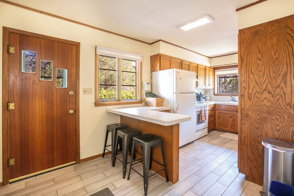 Kitchen leads to huge back privacy deck.