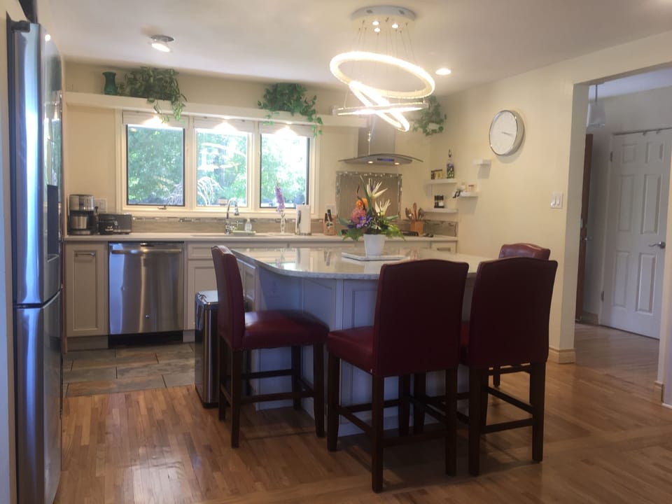 Kitchen with gas stove, microwave, pantry and a 2nd fridge under island.