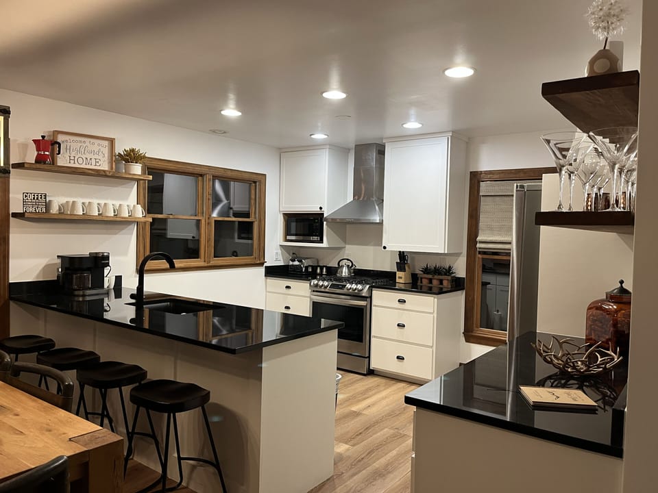 Newly renovated kitchen with gas stove and granite countertops.