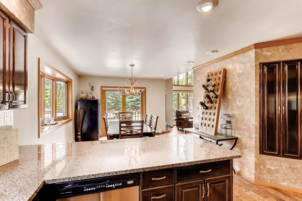 Notice all the windows that make the kitchen and dining room light and airy and a great place to hang out with your family and friends.