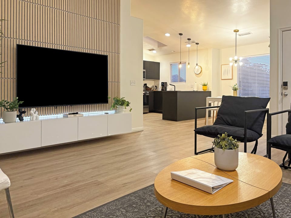 Large, modern & open plan living room with high ceilings and a 75" TV to relax
