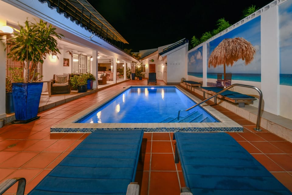 Fenced pool area at night
