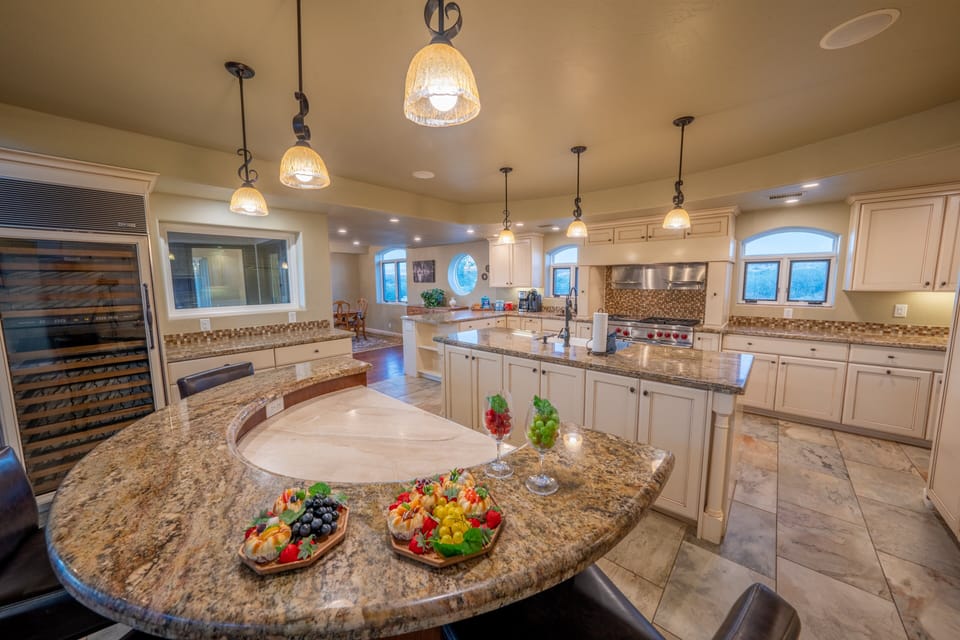 This Kitchen's Custom Design Includes A Chef's Table That Is Perfect For Entertaining
