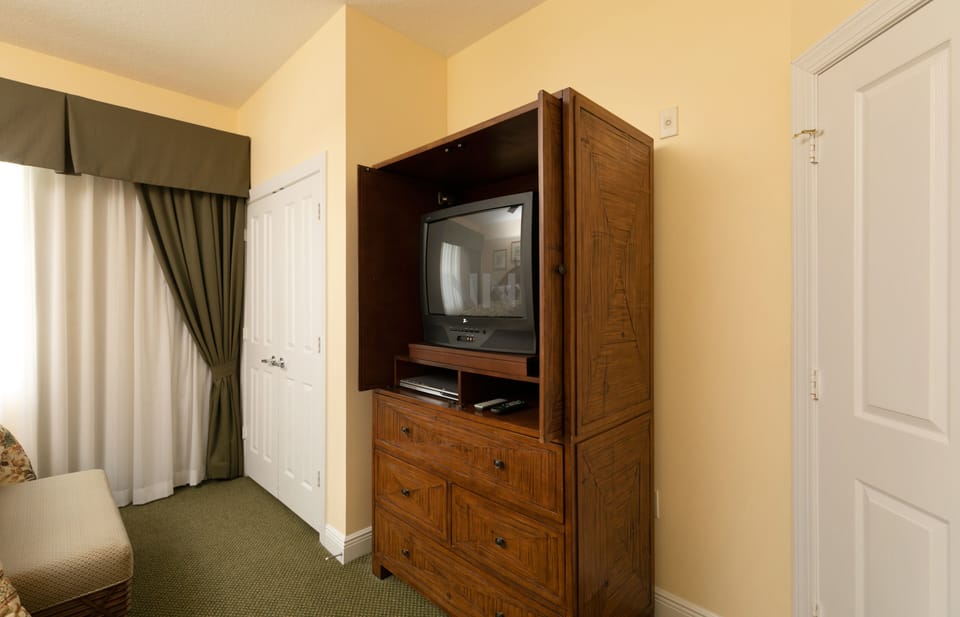 Room with two full-size beds and TV