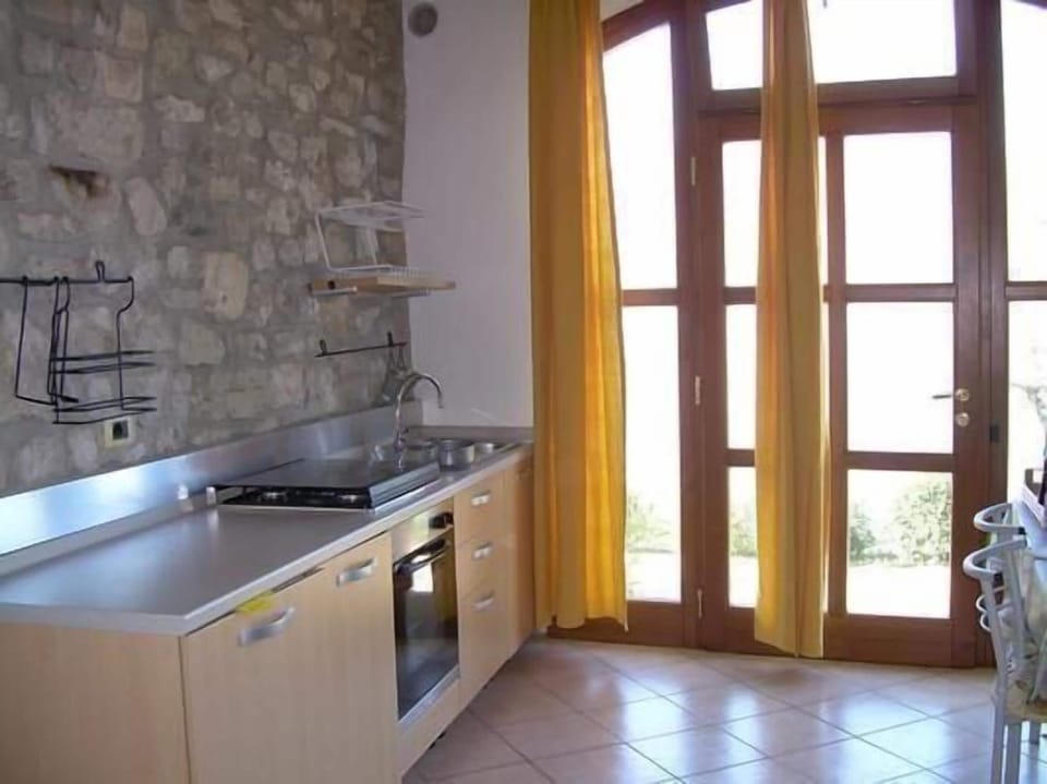 Kitchen complete with fridge, oven, toaster and moka