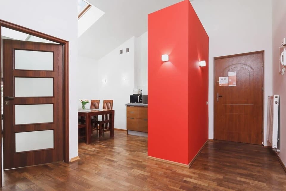 A view of the entry door with a glimpse of the dining table in the background, creating a welcoming atmosphere that flows seamlessly into the main living area.