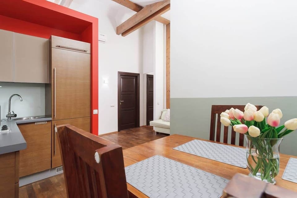 Another angle of the dining area, showing the kitchen in the background and showcasing the apartment’s open layout.