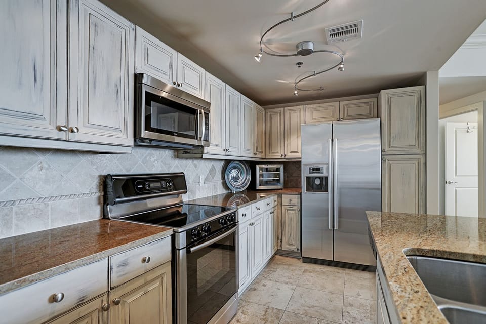 Spacious kitchen with stainless steel appliances and granite counter tops.