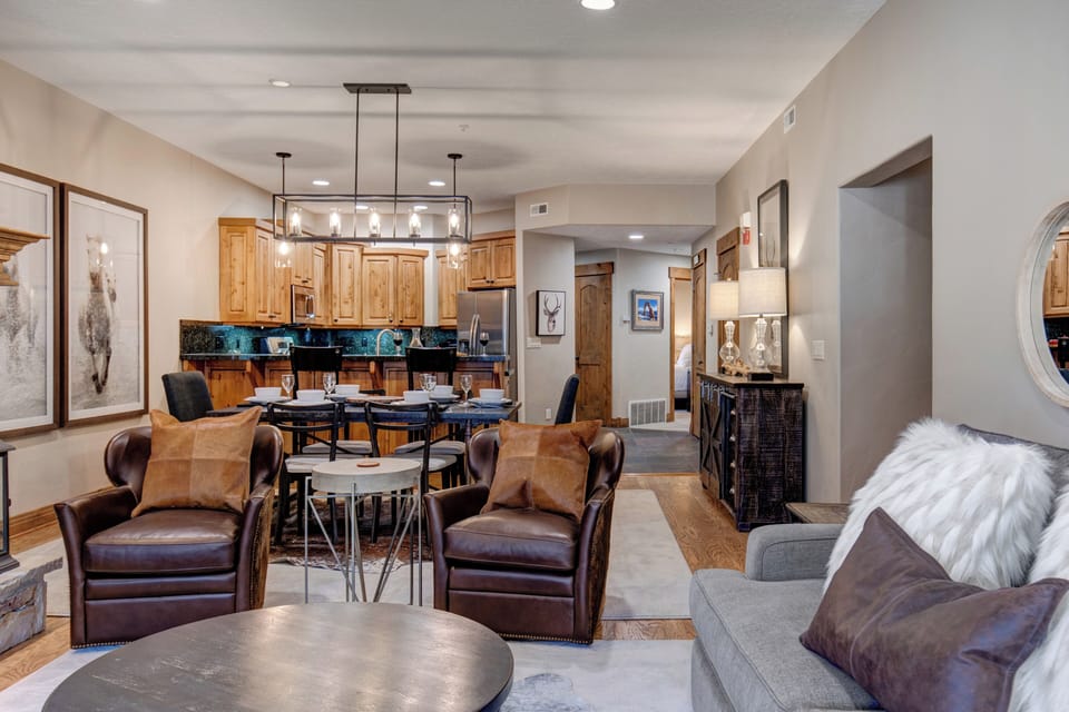 Relax in your spacious open-concept living area featuring plush leather seating, elegant dining space, and fully-equipped kitchen with modern finishes.