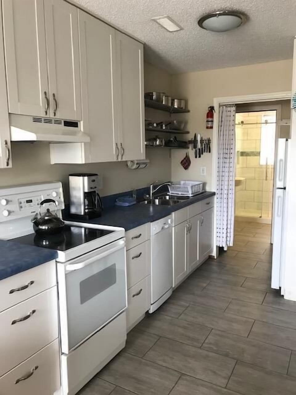 Bathroom and bedroom are just beyond the kitchen.   **Photo without wide lens provided for perspective**