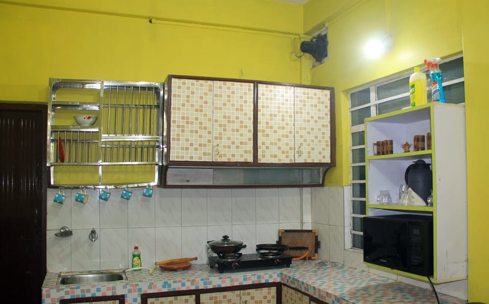 Kitchen with microwave and cooking essentials.