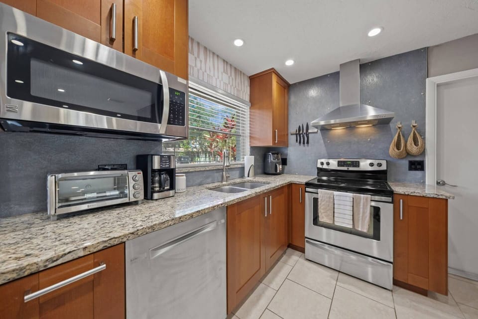 Stainless kitchen with granite counters. Access door to the spacious garage.