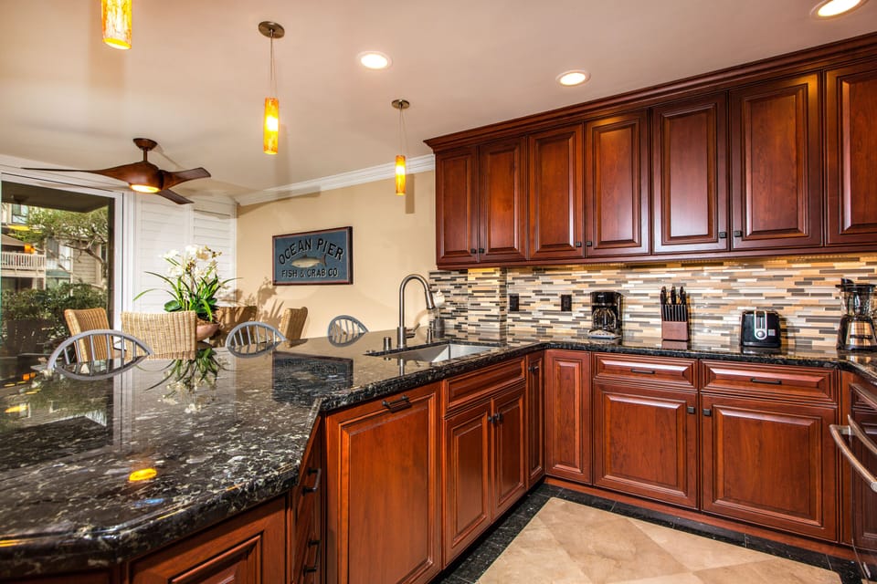 Over sized one bowl stainless steel sink with a stone and glass tile back splash
