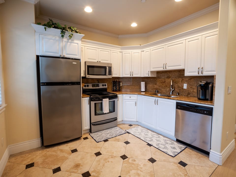 Large kitchen with essential equipped with stove,dishwasher,fridge,& microwave.