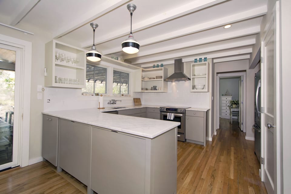 Modern Kitchen with all quality top of the line kitchenware. View of pool. 