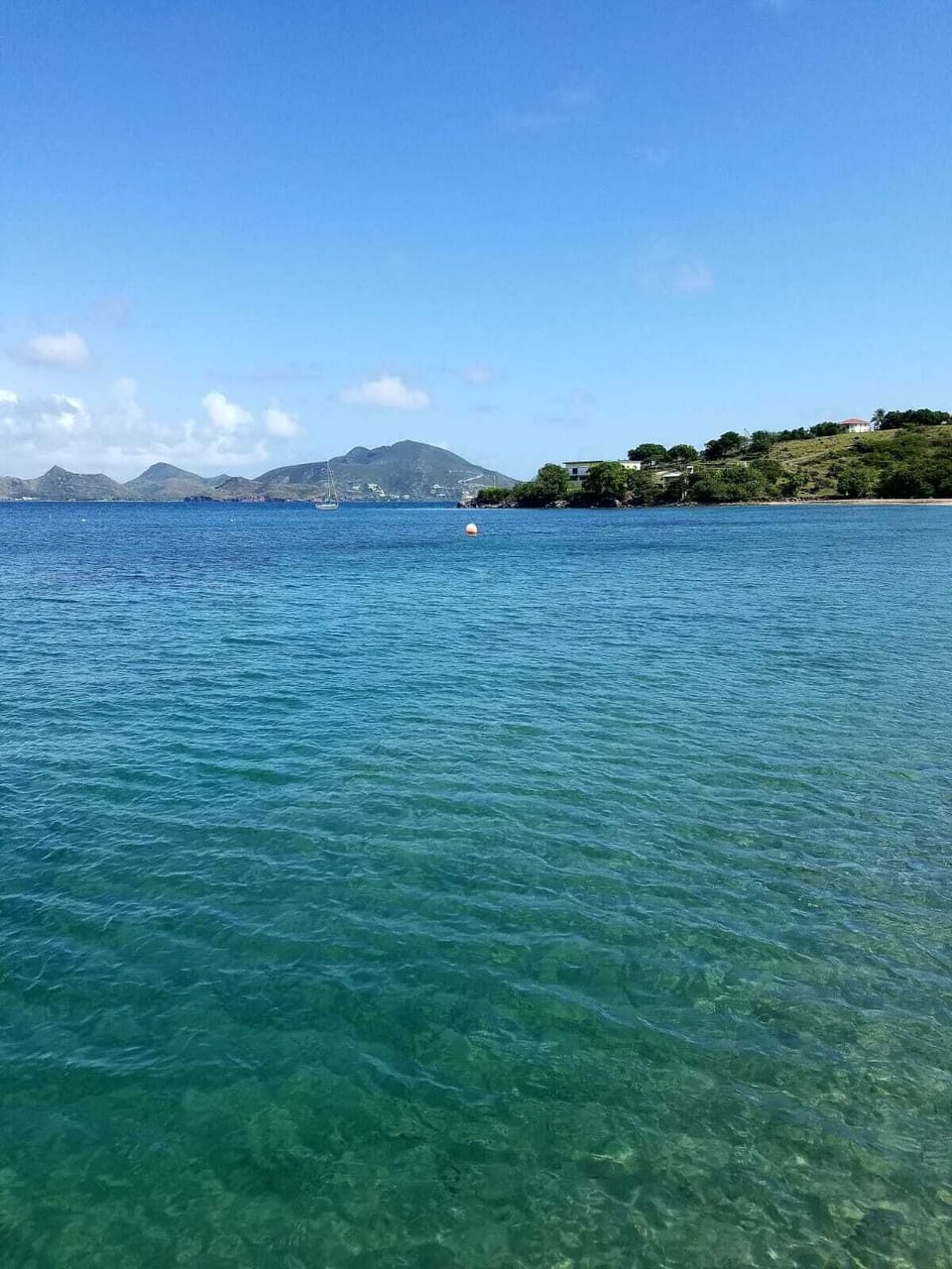 Welcoming cyan waters of Oualie Bay after a five minute walk