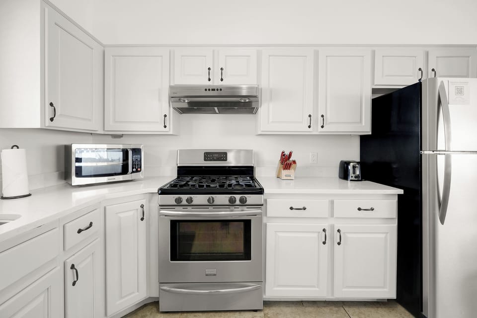 Kitchen, with a gas stove top, oven, and microwave