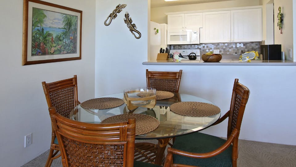 Dining room table close-up with kitchen in background. 
